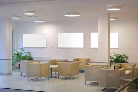 Empty waiting area with white chairs in a modern office. Interior for visitors.