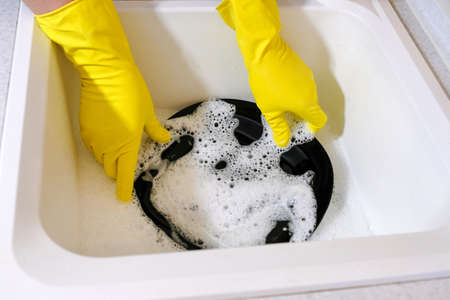 Hands of a man dishes washing in the sink. Homework in the kitchen.の写真素材