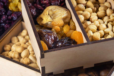 Nuts and dried fruit mix, healthy and wholesome food. Dried fruits with nuts. Cashews, hazelnuts,...