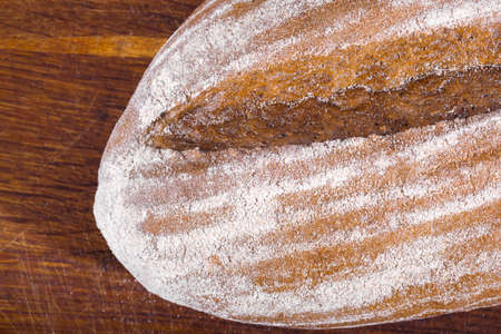 Freshly baked bread, on the kitchen board isolated on white.