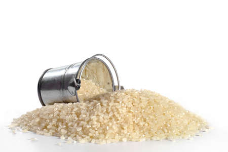 Inverted bucket with grains of rice on a white background.の写真素材