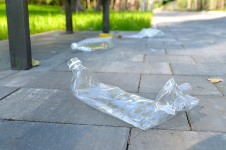 Garbage from plastic bottles, bags, paper, thrown away in a public park. Environmental problems. Environmental protection concept.の写真素材