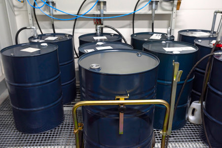 Blue metal barrels with gasoline, oil in a warehouse, close-up.