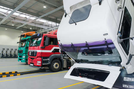 Servicing and repairing trucks in a large garage. Car service and truck maintenance. Auto mechanic...