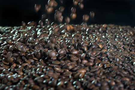 many flying coffee beans on black backgroundの写真素材