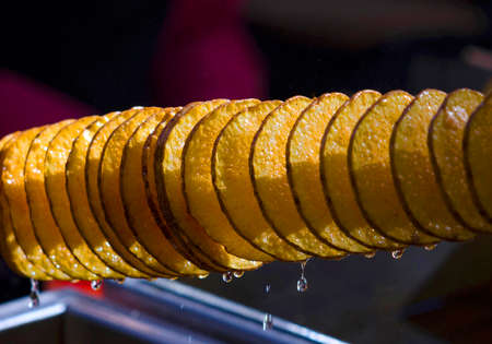 Juicy potato in oil in the form of a spiral.の写真素材