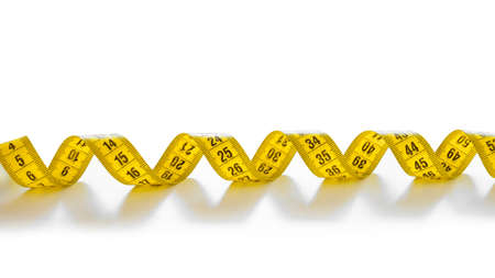 Yellow isolated metric measuring tape isolated on white background. Centimeter, close-up.