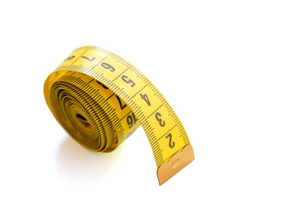Yellow measuring tape isolated on white background. Close-up. Side view.の写真素材
