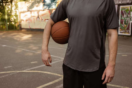 Young man playing with a basketball outdoors. Sports concept.の写真素材
