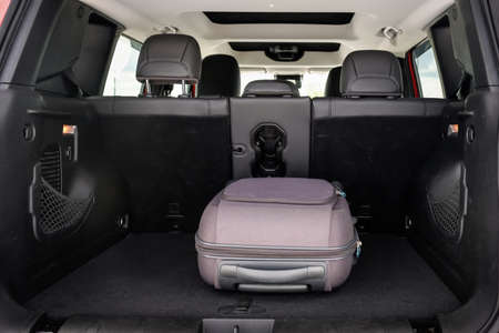 Suitcase for carry-on luggage in the trunk of the car. Transport, travel concept.の写真素材