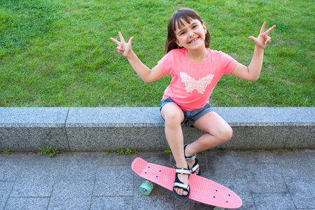 Happy little girl goes in for sports and poses for the camera. Sport, fitness lifestyle.の写真素材