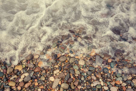 Pebbles on the sea shore, a view from aboveの写真素材