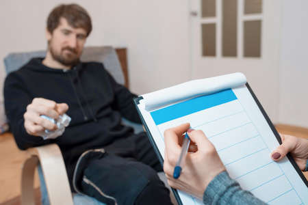 A man at a consultation with a psychologist in his office. Professional psychologist health care...