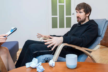 Middle-aged man in a psychologists office for a consultation. Social problems, depression, crisis.の写真素材