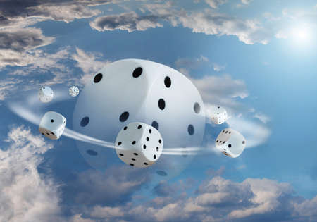 A set of six-sided cubes are going round a big cube in the blue sky in close-up.の写真素材