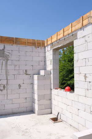 Building a house from a white gas block or foam block at a construction site. White house made of gas blocks on the siteの写真素材