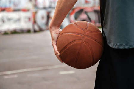 Basketball player with a basketball ball on an outdoor sports ground. Sports conceptsの写真素材