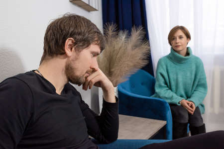 A man in depression consults with a doctor or psychologist, complains about his health, has problems.の写真素材