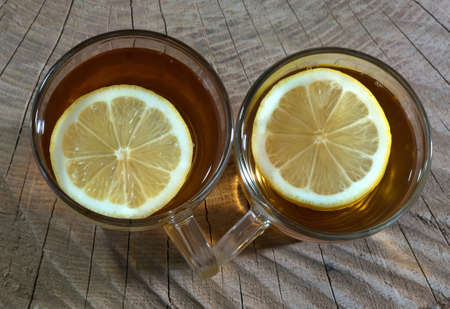 Black tea with a lemon in a glass cup. Top view.の写真素材