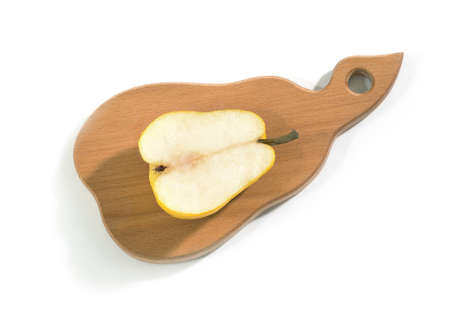 A half of a ripe pear on a tray, on the isolated white background, the top view.の写真素材