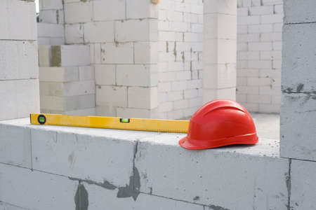 Construction safety helmet and construction level at the construction site. Construction of a...