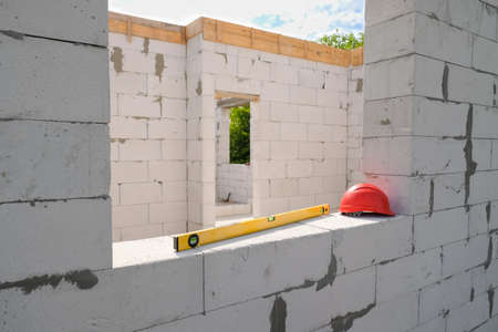 White house from aerated concrete blocks or foam blocks at a construction site. Building a house on the site.の写真素材