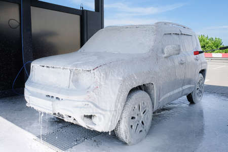 Car in foam at a car wash. Car wash with soap, car wash.の写真素材