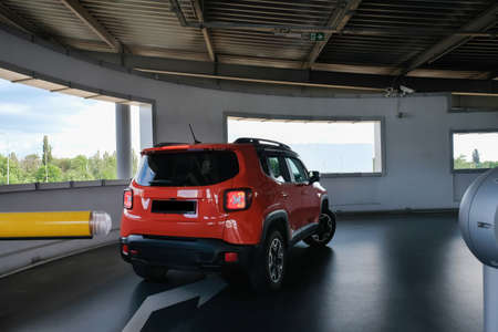The car drives into the underground parking lot. Back view.の写真素材