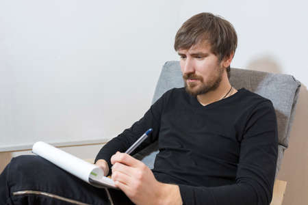 A patient sitting in the office of a psychotherapist takes a psychological test. Mental healthの写真素材