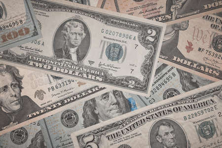 Background from US dollars. Close-up of a lot of dollar bills banknotes. American currency.の写真素材
