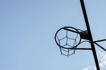 Silhouette of basketball metal hoop on sky background.の写真素材