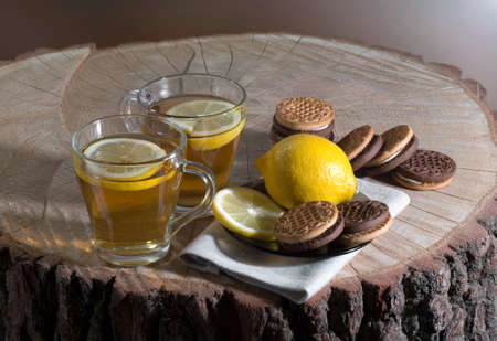 Hot tea in the open air with cookies and a lemon.の写真素材
