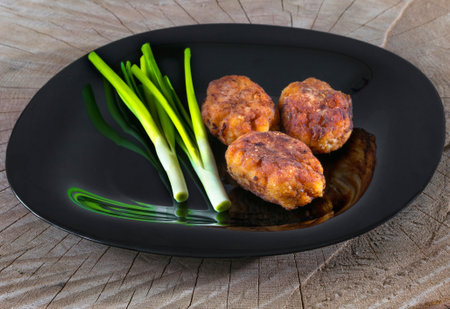 Juicy cutlets on a wooden background, outdoors.の写真素材