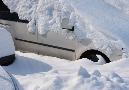 A car is covered by white snowの写真素材