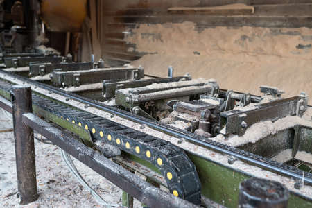 Old equipment for cutting wood at a sawmill. Woodworking industry.の写真素材