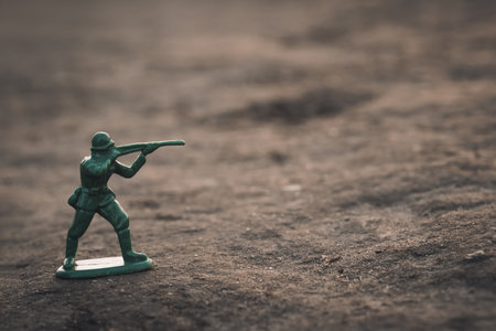 Image of a toy soldier outdoors. War concept, side view.の写真素材