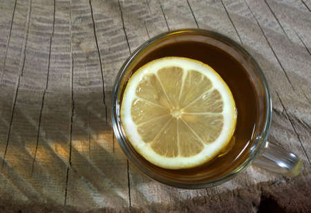 Black tea with a lemon in a glass cup. Top view.の写真素材