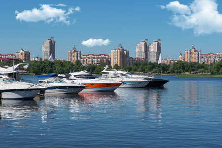 Kiev, Ukraine - June 01, 2018 : White yachts in the port, against the backdrop of the city. Yachts docked in river portのeditorial素材