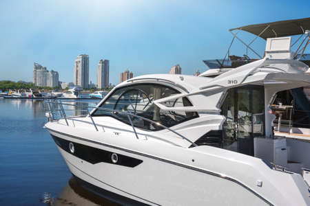 Kiev, Ukraine - June 01, 2018: Luxury yachts on the background of skyscrapers with water reflectionのeditorial素材