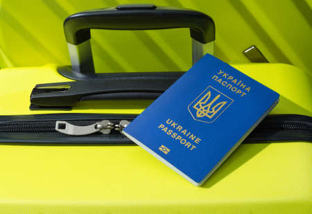 Passport of the traveler. Suitcase close-up. At the international airport with a Ukrainian passport.の写真素材