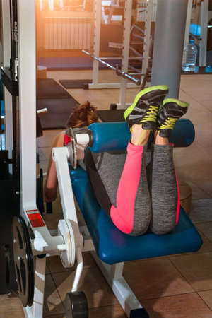 The active girl trains legs in the gym.の写真素材