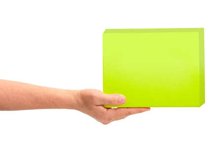 Gift green box in male hand, isolated on white backgroundの写真素材