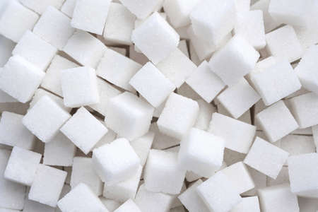 Background of refined sugar. Close-up of white sugar cubes.の写真素材