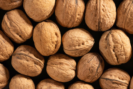 Heap of whole walnuts in the shell close-up. Healthy organic products, top viewの写真素材