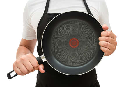 Male chef with a frying pan in his hands on a white isolated backgroundの写真素材
