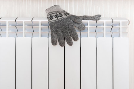 Warm gloves on the radiator. Heating season conceptの写真素材