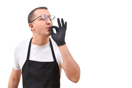 Professional chef in an apron gesturing with his hands on a white background. The concept of cookingの写真素材