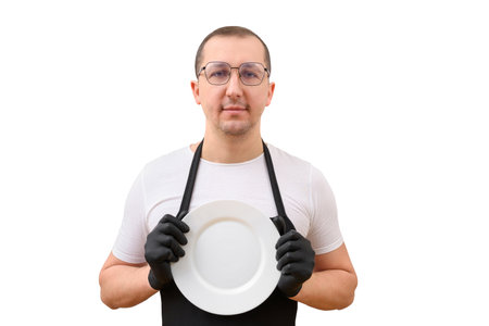 Portrait of a male chef with a plate in his hands looking at the camera on a white background.の写真素材