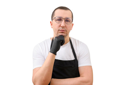 Portrait of a man in an apron and gloves on a white background. The concept of cookingの写真素材