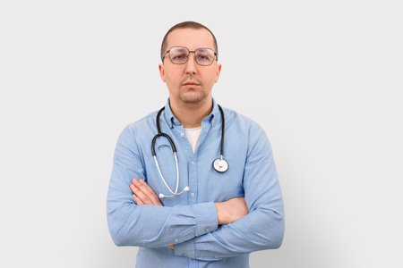 Portrait of a serious male doctor on a white background. Health care and medicineの写真素材